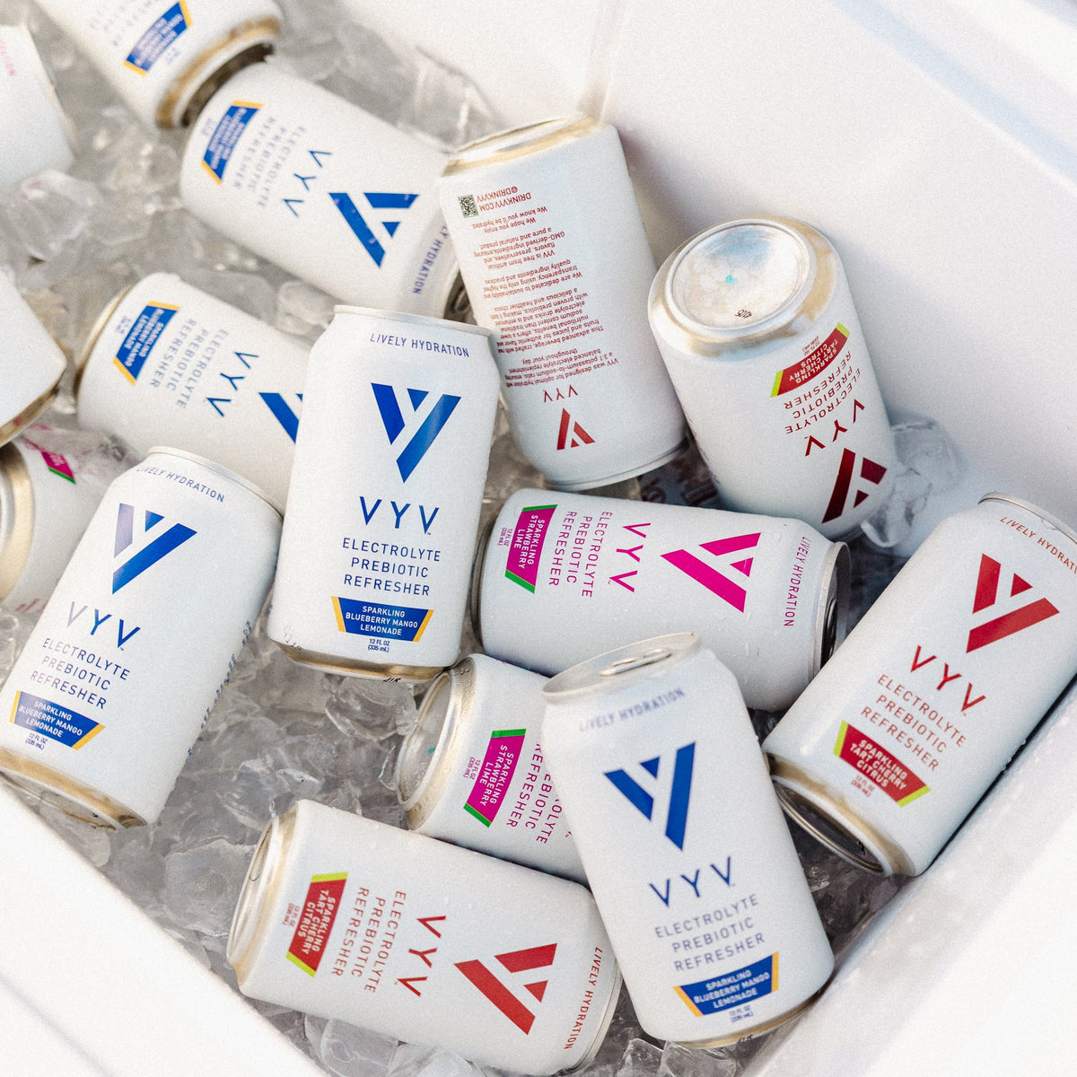 VYV cans on ice in a cooler: Blueberry Mango Lemonade, Strawberry Lime and Tart Cherry Citrus